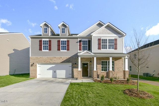 craftsman house with driveway, a porch, a front yard, and brick siding