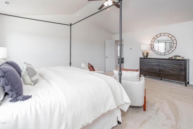 bedroom with ceiling fan, visible vents, vaulted ceiling, and light colored carpet