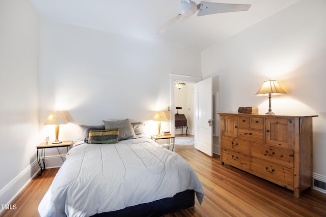 bedroom featuring a ceiling fan, baseboards, and wood finished floors