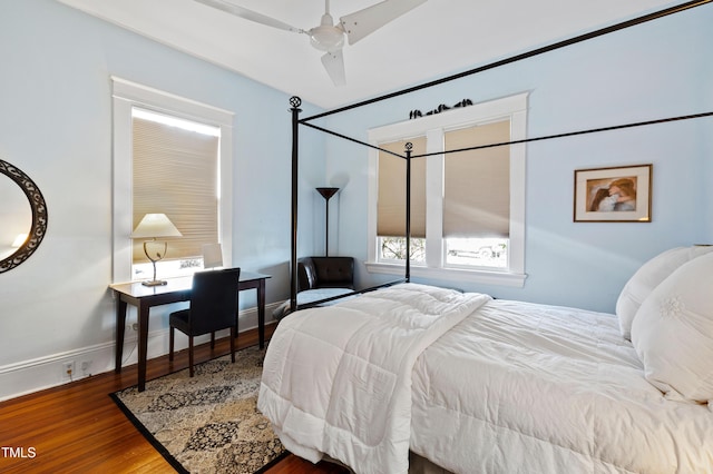 bedroom featuring wood finished floors and baseboards