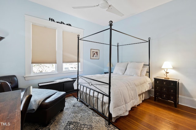 bedroom with wood finished floors, baseboards, and ceiling fan