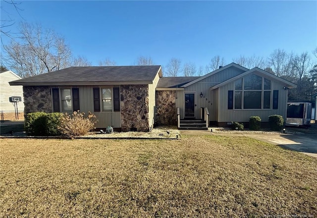 ranch-style house with stone siding and a front yard