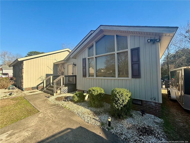 view of side of home featuring crawl space and board and batten siding