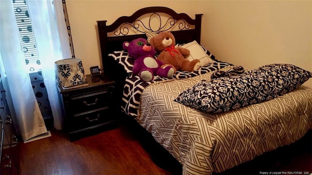 bedroom with dark wood-style floors