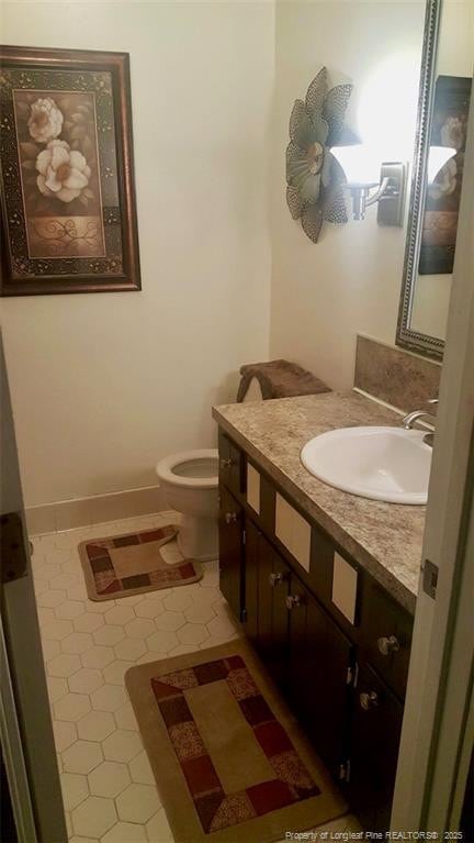 bathroom with vanity, toilet, and tile patterned floors