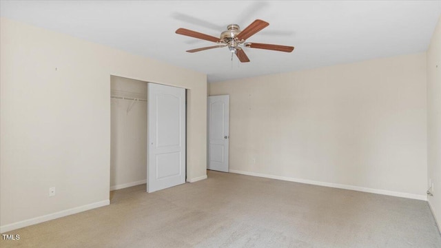 unfurnished bedroom with a ceiling fan, baseboards, a closet, and light colored carpet