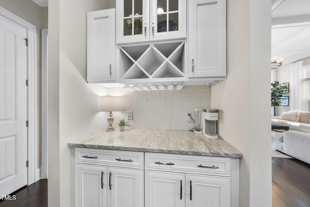 bar featuring dark wood finished floors and decorative backsplash