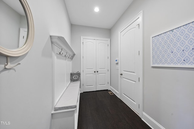 mudroom featuring baseboards and dark wood finished floors