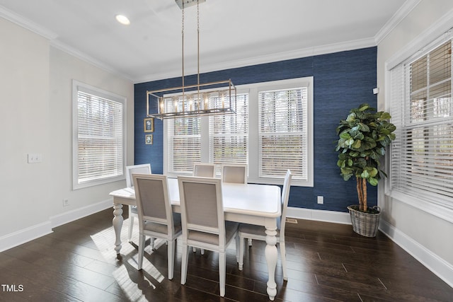 dining space featuring baseboards, wallpapered walls, wood finished floors, and crown molding