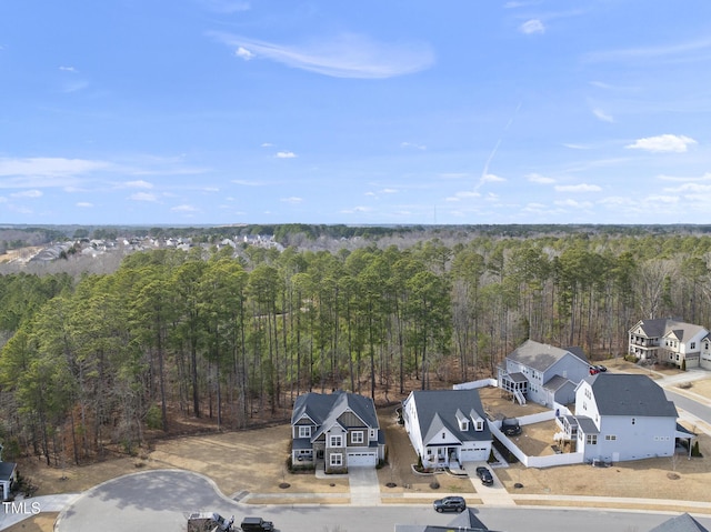 birds eye view of property with a wooded view