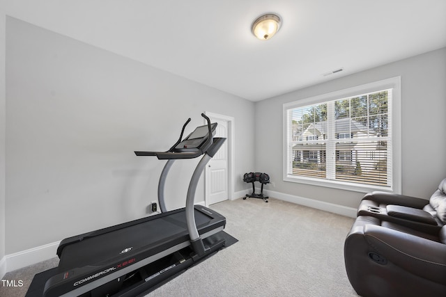 workout area with light carpet, baseboards, and visible vents