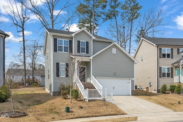 traditional-style home with concrete driveway, stairway, and an attached garage