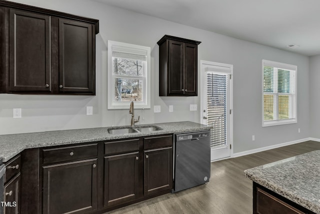 kitchen featuring wood finished floors, a sink, baseboards, dark brown cabinets, and dishwasher