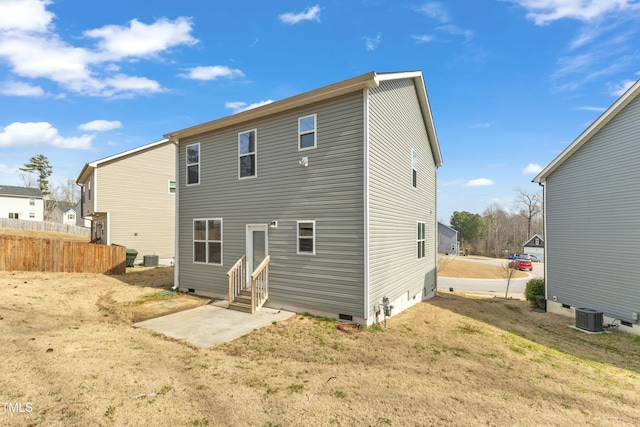 back of property featuring entry steps, central AC unit, fence, a yard, and crawl space