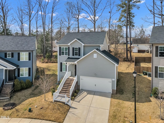 view of front of property with a garage, stairway, and concrete driveway