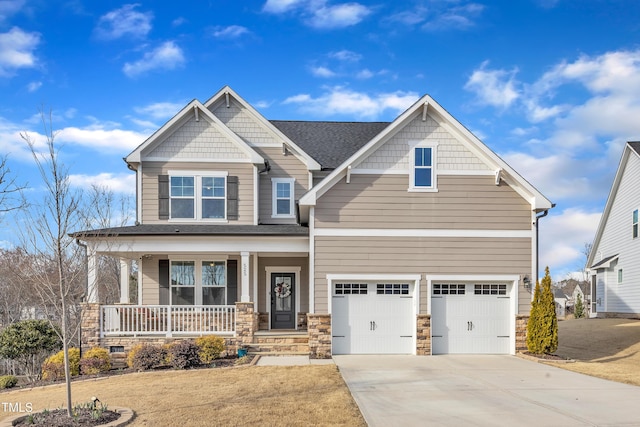 craftsman-style home with roof with shingles, a porch, a garage, stone siding, and driveway