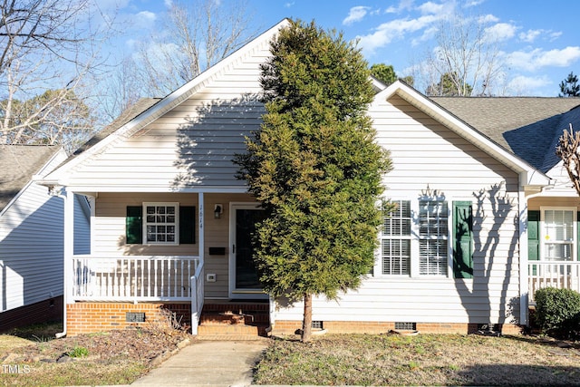 bungalow with crawl space, covered porch, and a shingled roof