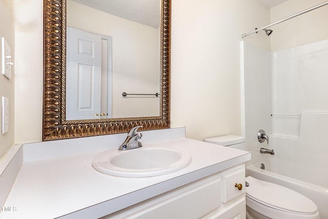 bathroom featuring tub / shower combination, vanity, and toilet