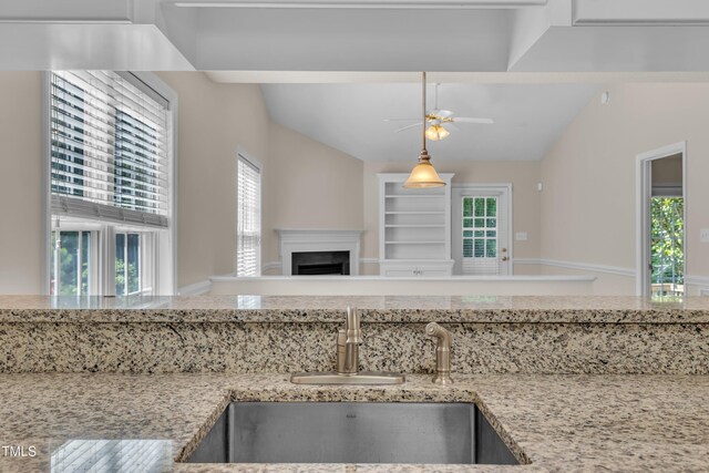 1614 W Cotton Gin Dr, Clayton, NC 27527 - kitchen with a sink, vaulted ceiling, a ceiling fan, plenty of natural light, and open floor plan