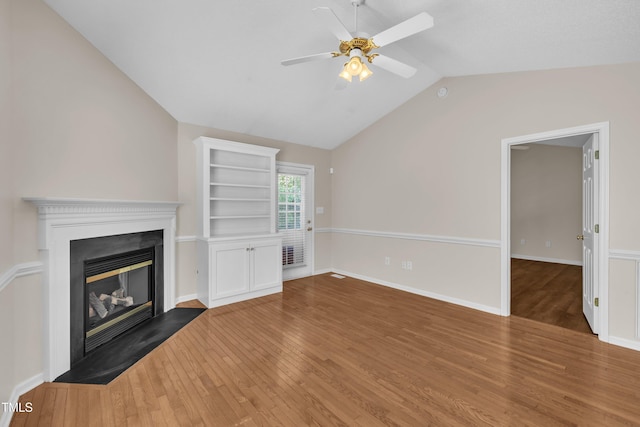 1614 W Cotton Gin Dr, Clayton, NC 27527 - unfurnished living room with a glass covered fireplace, ceiling fan, wood finished floors, lofted ceiling, and baseboards