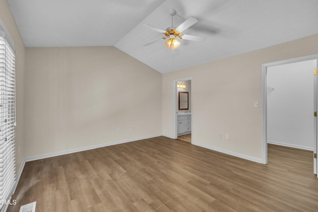 1614 W Cotton Gin Dr, Clayton, NC 27527 - unfurnished bedroom with a spacious closet, wood finished floors, baseboards, vaulted ceiling, and ensuite bath