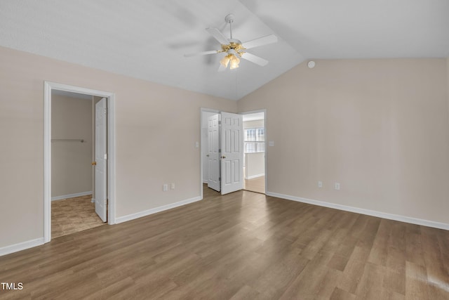 1614 W Cotton Gin Dr, Clayton, NC 27527 - unfurnished bedroom featuring a spacious closet, wood finished floors, lofted ceiling, and baseboards