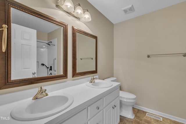 1614 W Cotton Gin Dr, Clayton, NC 27527 - bathroom with toilet, double vanity, baseboards, and a shower