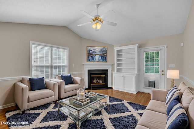 1614 W Cotton Gin Dr, Clayton, NC 27527 - living room with a ceiling fan, wood finished floors, vaulted ceiling, a fireplace with flush hearth, and baseboards