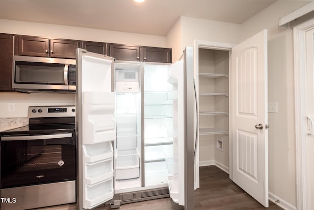 kitchen featuring dark brown cabinetry, baseboards, light countertops, appliances with stainless steel finishes, and dark wood finished floors