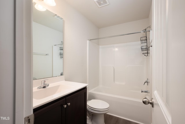 full bath featuring toilet, wood finished floors, vanity, visible vents, and shower / bathing tub combination