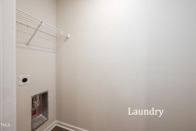 laundry area with laundry area, baseboards, and electric dryer hookup