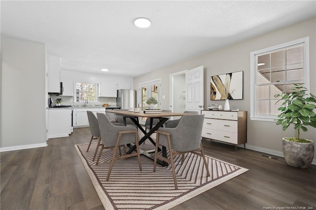 dining room with dark wood-style floors and baseboards