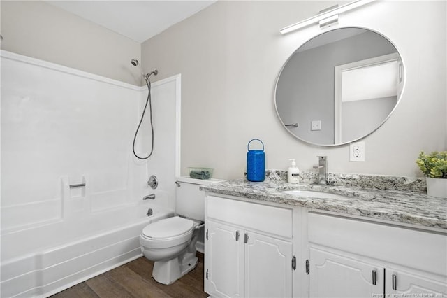 full bath featuring tub / shower combination, vanity, toilet, and wood finished floors