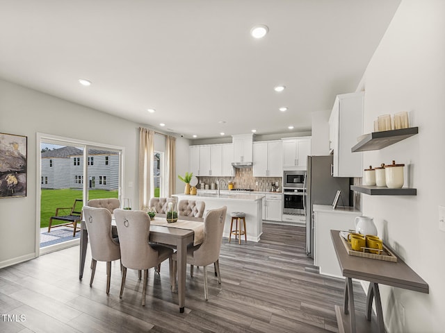 dining room featuring dark wood-style floors, baseboards, and recessed lighting