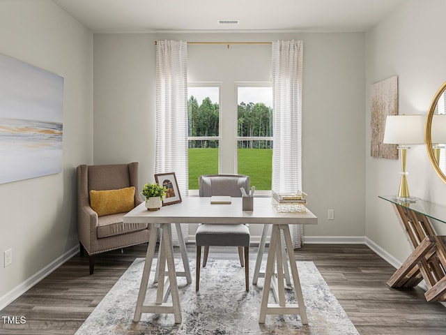 interior space featuring dark wood-style floors, visible vents, and baseboards