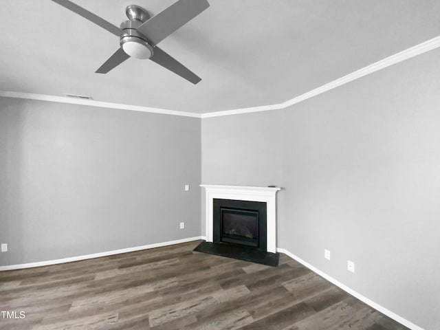 unfurnished living room featuring crown molding, dark wood finished floors, and a fireplace with flush hearth