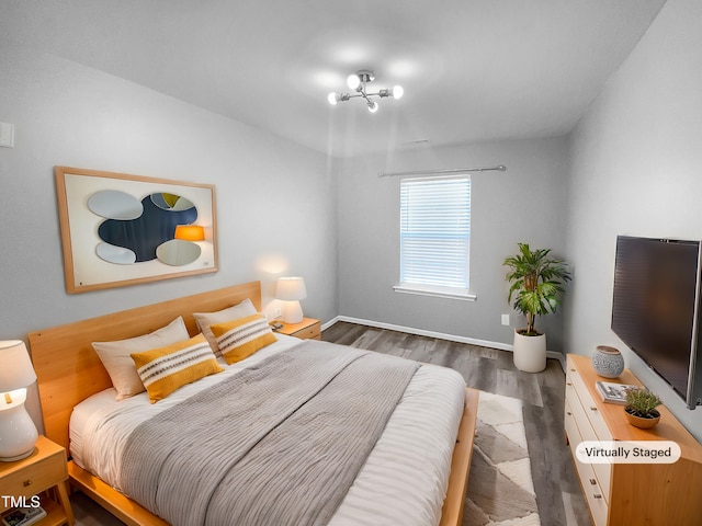 bedroom featuring baseboards and dark wood-style flooring