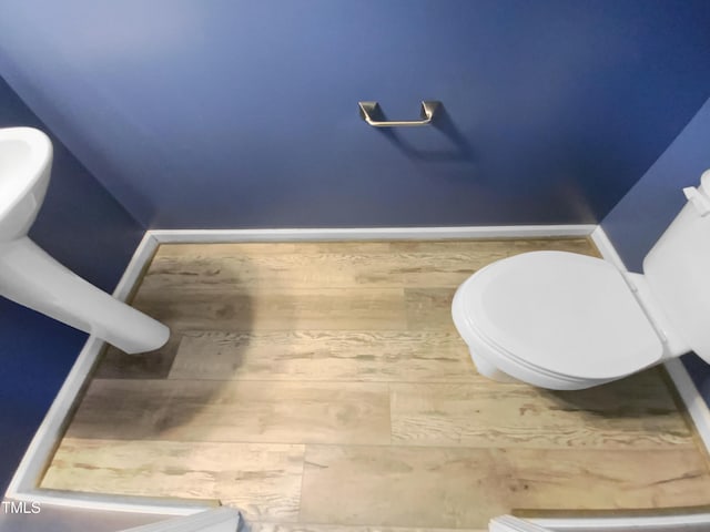 bathroom with toilet and baseboards