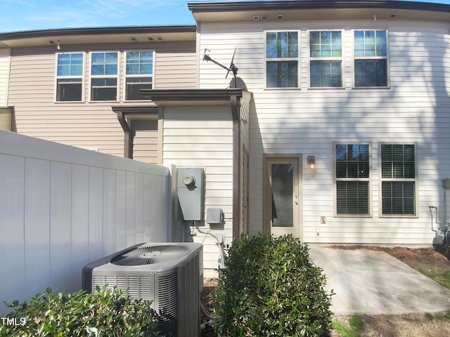 exterior space featuring a patio area, cooling unit, and fence