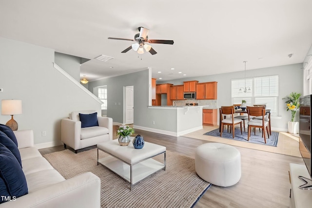 4508 Brintons Cottage St, Raleigh, NC 27616 - living area with light wood-type flooring, ceiling fan, baseboards, recessed lighting, and a chandelier