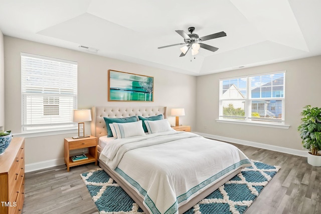 4508 Brintons Cottage St, Raleigh, NC 27616 - bedroom with a tray ceiling, baseboards, light wood finished floors, and ceiling fan