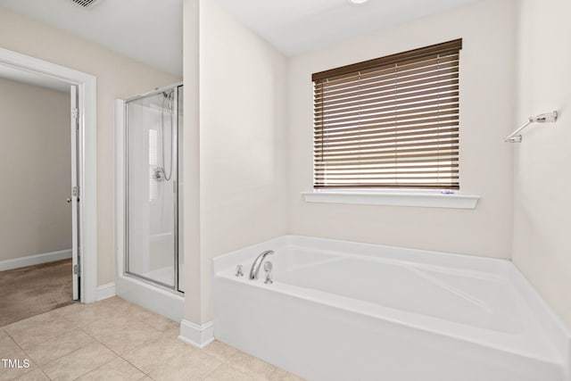 4508 Brintons Cottage St, Raleigh, NC 27616 - bathroom featuring a shower stall, a bath, tile patterned floors, and baseboards