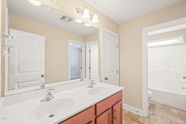 4508 Brintons Cottage St, Raleigh, NC 27616 - bathroom with double vanity, toilet, and baseboards