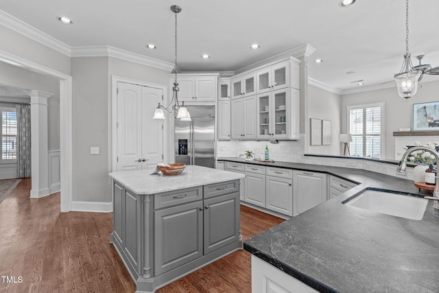 kitchen with white cabinets, dark wood-style flooring, gray cabinetry, a sink, and built in fridge