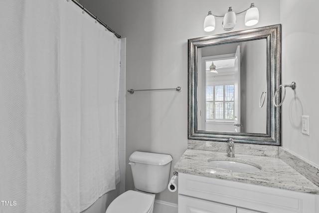 full bath with curtained shower, vanity, and toilet