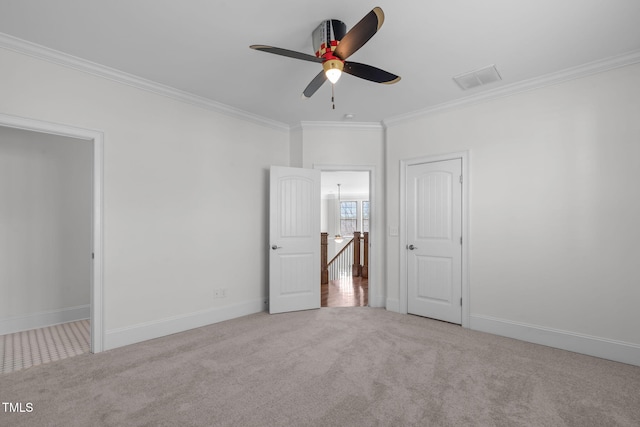 unfurnished bedroom featuring baseboards, carpet, visible vents, and crown molding