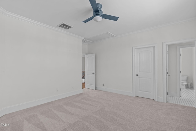 unfurnished bedroom featuring attic access, visible vents, crown molding, and carpet flooring