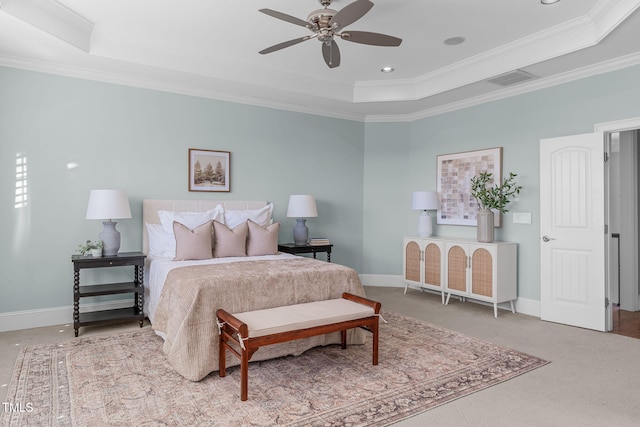 carpeted bedroom featuring a raised ceiling, crown molding, and baseboards