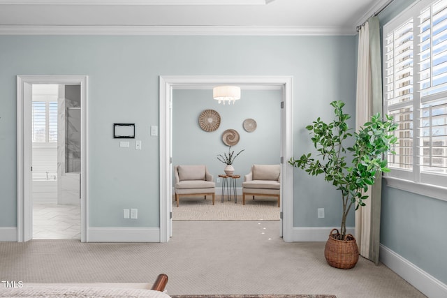 living area with baseboards, plenty of natural light, and crown molding