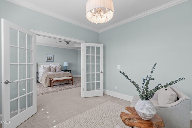 sitting room with baseboards, ornamental molding, an inviting chandelier, carpet flooring, and french doors